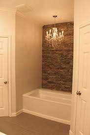 My Tub With Faux Stone Wall Accent Wall And Chandelier Faux Stone Walls House Bathroom Home Remodeling