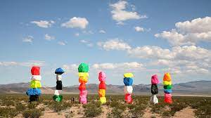 If you're rocketing down interstate 15 on your way too or from las vegas, and look off to the east, you might just make out seven giant pillars of stacked colored rocks. Seven Magic Mountains Outside Of Las Vegas Nevada