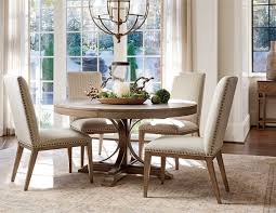 Round dining table sets are great for smaller dining rooms, while a rectangular option is great for longer rooms. The Sweeping Textured Metal Pedestal Rests On A Wooden Base Comfortably Seating 4 In The Round Or Add Dining Table Round Dining Table Extendable Dining Table