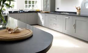 Dramatic colours such as dark grey and blue look fabulous in modern and contemporary kitchens. Kitchen Stone Flooring And Stone Worktops Stone Wall Tiles Taupe Kitchen Grey Kitchen Cupboards Grey Kitchens