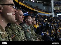 From left to right) Spc. Kenneth Fahle, Sgt. Richard Risden, Spc. Paul  Munger and Sgt. 1st class Derrick Reed from the 101st Airborne Division  Brass Band watch the Nashville Predators hockey game