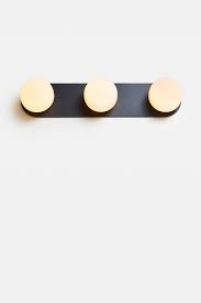 The rubbed bronze fixtures are paired with rubbed bronze shades. Pastille Vanity Matte Black Vanity Sconce Black Vanity Light Black Light Fixture