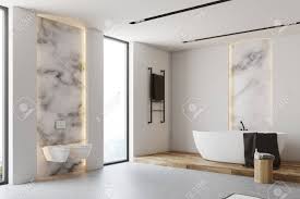 An aesthetic small contemporary corner bath of resistant white acrylic. White And Marble Bathroom Corner With A Gray Floor A White Bathtub Stock Photo Picture And Royalty Free Image Image 91305689
