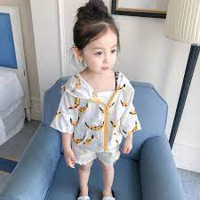 4k00:07innocent asian young toddler sitting in the baby chair at home is looking away while being fed with pureed food by her mom at breakfast. Kids Children Girl Cute Korean Yellow Banana Cardigan Jacket