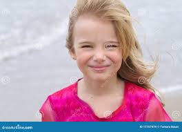 Little Blond Girl with Ocean Behind Her Stock Photo