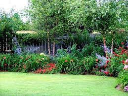 Plant these perennials for sun in your brightest. Small Sunny Backyards Flower Garden Design For Small Backyards Natural Flowers Black Fence Perennial Garden Perennial Garden Design Flowers Perennials