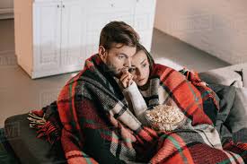 Watch or download free movies online in high quality right now! High Angle View Of Emotional Young Couple Watching Movie With Popcorn On Couch And Covering With Plaid Stock Photo Dissolve