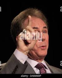 Stock car race driver Darrell Waltrip of Franklin, Tenn. victoriously holds  his arms aloft in the winner's circle with his trophy after winning the  Winston Western 500 January 14, 1979. Waltrip receives