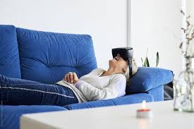 Senior Woman Lying On Sofa With Virtual Reality Headsets On Watching Movie And Laughing Virtual Reality Virtual Reality Headset Virtual