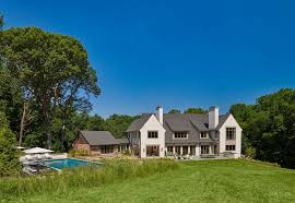 Characteristics of a modern farmhouse exterior. Modern English Country Home Barnesvanze Architects