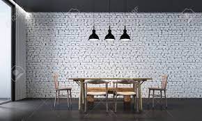 Dining space in the corner of industrial living area with a conservatory roof. The Interior Design Of Dining Room And White Brick Wall Stock Photo Picture And Royalty Free Image Image 90332140