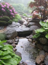The main part of the showcase is around the negative edge pond. Garden Pond And Stream With Stone Bridge Traditional Landscape Miami By Matthew Giampietro Garden Design Houzz