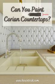 Oak cabinets resurfaced in creamy white (visible wood grain). Can You Paint Corian Countertops House Trick