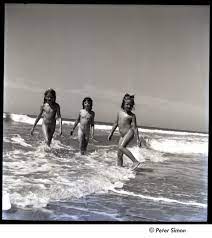 Lucy Simon, unidentified girl, and Carly Simon play in the ocean, ca. 1952
