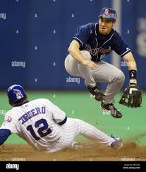San Diego Padres second baseman Mark Loretta leaps over Montreal Expos' Wil  Cordero to complete the double play during 4th inning NL action in Montreal  ,Tuesday, May 6, 2003. (AP Photo/Ryan Remiorz