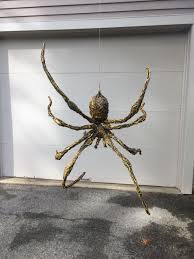 Spiders don't always have to be black! Easy Diy Hanging Spider Made From Aluminum Foil And Wire Armature Covered In Hot Glue Posable Scary Halloween Halloween Outdoor Decorations Outdoor Halloween