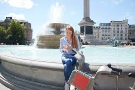 Check spelling or type a new query. Woman Using Smart Phone While Having Snacks At Fountain In City Stockphoto