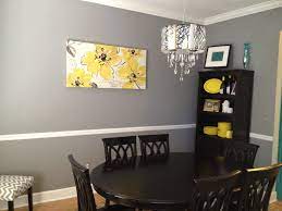 The shiplap yellow walls match the finish of the gray wood dining room cabinet by the head of the beige wooden table and its beige wooden chairs with lovely designs on its backs that are matching the area rug yellow patterns. Pin By Amber Peebles On Stuff For The Home Yellow Dining Room Dining Room Colors Grey Dining Room