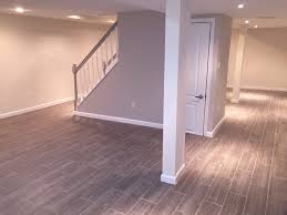 Basement Finished Basement Finishing Ideas With Laminate Wood Flooring Around Cream Painted Wall And Basement Remodeling Basement Makeover Basement Renovations