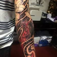 Red and black band tattoo on arm. 108 Amazing Japanese Tattoos That Are Very Cultural