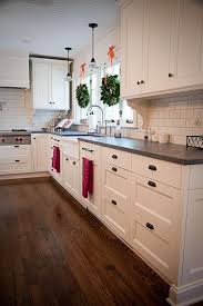 Bronze, brass and black cabinet hardware are trending. White Cabinets Honed Slate Counter Tops Black Handles Kitchen Cabinets Decor Home Kitchens Kitchen Design