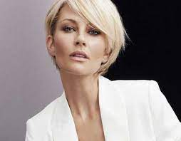 With a small curly bun at the back, this hairstyle is completed with asymmetric curls out in the front. Elegant Short Haircuts For Older Women