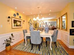 It's a gorgeous indigo blue with an ikat border. Pale Yellow Dining Room With Mirrored Wall And Blue Chairs Hgtv