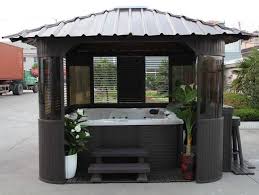 This Portable Hot Tub Gazebo Features A Riveted Roof Tinted Glass Windows And Enough Extra Space To Add Some Plant Hot Tub Gazebo Hot Tub Landscaping Gazebo
