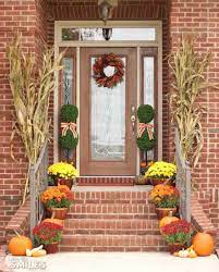 Oversized mums, pumpkins, lanterns and cornstalks would be a great addition to a fall wreath. Front Porch Fall Decor 2021