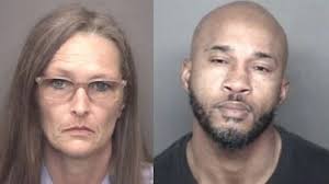 Wife and convicted murderer charged in firefight's killing