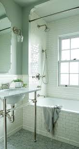 Bright and classic master bathroom with calacutta marble wainscot and white console sinks. Glass And Marble Sink Vanity With Small Marble Herringbone Tiles Transitional Bathroom