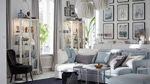 A modern white living room chair and sofa match a statement spiral staircase in this striking space. A Wall To Wall Gallery In Your Living Room Ikea