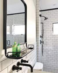 Modern Industrial Bathroom With White Subway Tile And Black Grout Ties In Beautifully With White Bathroom Tiles White Subway Tiles Industrial Bathroom Lighting