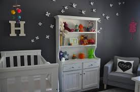 Nursery room with gray and white patterned walls and a hardwood flooring lighted by a cute chandelier. 50 Gray Nurseries Find Your Perfect Shade Project Nursery