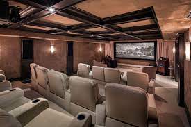 This modern media room boasts a theater space with sectional sofa seats along with a small bar on the side set on the red velvet carpet flooring matching the red elegant walls. Pin On Real Estate