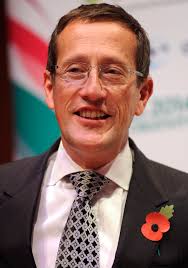 The reporter, wearing a face mask, could be seen being cuffed by two armed policemen. Richard Quest Wikipedia