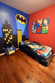 My sons new superhero room with batman light signal superhero. Boy S Batman Superhero Themed Room With Bat Signal Over The City Wall Mural Batmobile Bed And Custom Canvas Themed Kids Room Batman Room Batman Themed Bedroom