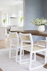 Light Blue Board And Batten Wall Detail White Kitchen Hood Cane Dining Chairs Kara Theresa Cane Dining Chairs Transitional Dining Room Wood Dining Table