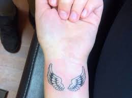 The model is wearing the large. Heart With Angel Wings Tattoo On Wrist Tattoo Design