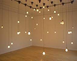If you want a more relaxed look to your lights, let them hang down slightly from the ceiling instead of pulling them tight. Installation Art Installation Art Featuring A Collection Of Moving Hanging Lightbulbs Hanging Art Installation Light Bulb Art Lamp Installation