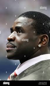 Michael Irvin, former Dallas Cowboys wide reciever, poses for a snapshot  with a young fan at the Football Hall of Fame Enshrinement Ceremony