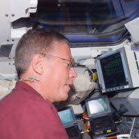 U.S. Navy Fire Controlmen off-load a NATO AIM-7 Sea Sparrow missile from a  launcher aboard the Nimitz Class Aircraft Carrier USS THEODORE ROOSEVELT  (CVN 71)