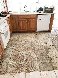 I have tiles that go under my existing kitchen cabinets and want to put in new engineered wood floors throughout. How To Remove Tile Floors The Harper House Tile Removal Kitchen Flooring Tile Floor Diy