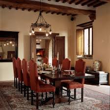 A farmhouse chandelier over your dining table complemented by mediterranean style wall sconces and a candelabra can make it feel like you're in the tuscan countryside. Settled In Tuscany Villa Tour Dining Room