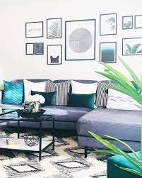This living room has a striking wood wall that becomes the element that divides the window seat beyond. 15 Teal And Grey Living Room Ideas