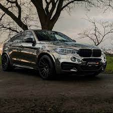 With A Chrome Black Full Body Wrap 22 Inch Wheels A Suspension Lowering Kit And A Power Upgrade This Look At Me Bmw X6 M50d Is Anythin Bmw X6 Bmw X6 Black Bmw