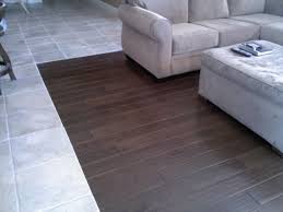 He has used a silver strip at the transition point, which is fine. Black Wood Look Floor Tile Novocom Top