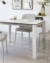 Utensils are placed inward about 20 cm or 8 inches from the edge of the table, with all placed either upon the same invisible baseline or upon the same invisible median line. White Frosted Glass Extending Dining Table With Brushed Steel Legs Danetti