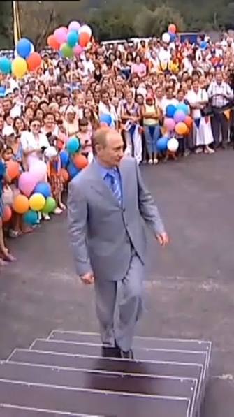 Russian President Vladimir Putin surrounded by children during a tightly controlled public appearance in Novosibirsk.