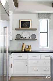 The globe is securely housed in a black stand and. Contemporary White Kitchen Counter With Bronze Accents Luxe Interiors Design
